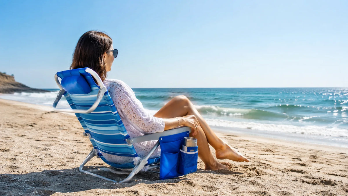 Beach chair set up on sandy shore showing common sinking problem with narrow legs