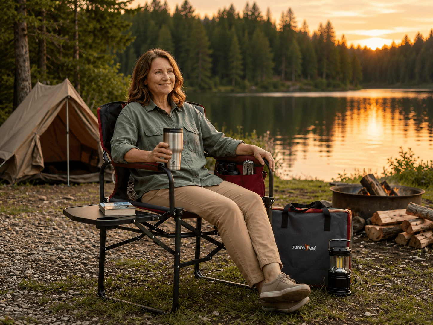 Woman relaxing in a camping chair by a lakeside forest at sunset, with a tent and camping lantern nearby