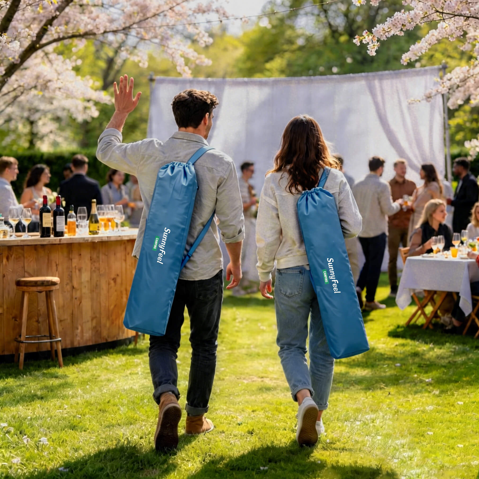 Two people walking outdoors with blue bags, cherry blossoms and a wooden bar in the background.
