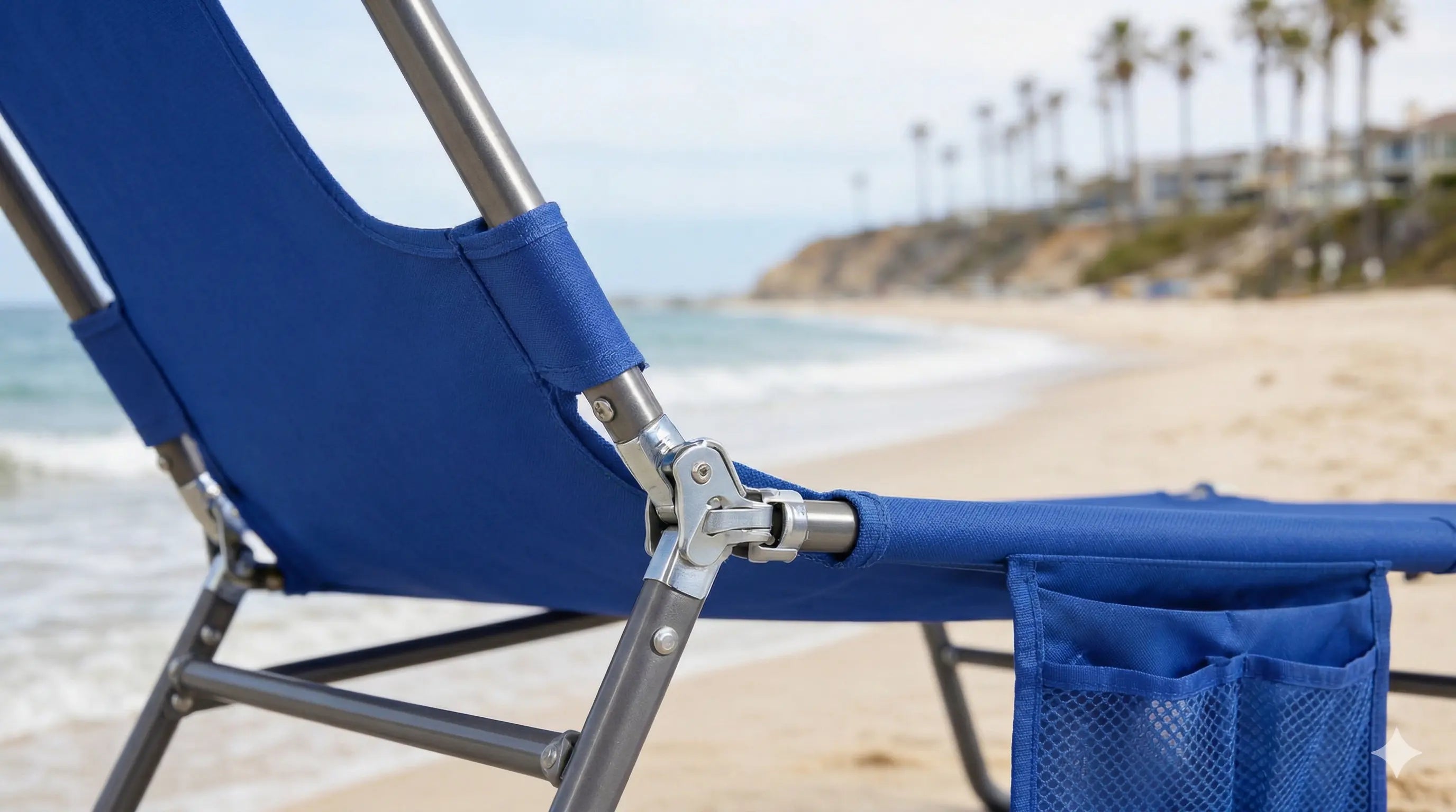 Blue beach chair on a sandy beach with ocean and palm trees in the background