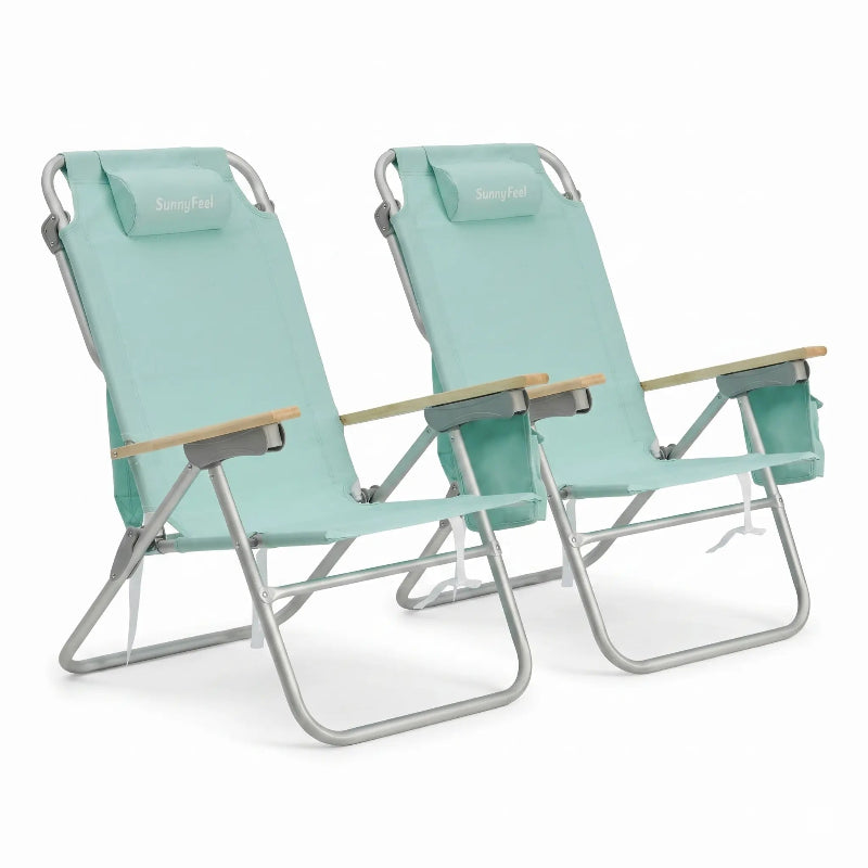 Two mint green folding beach chairs with wooden armrests on a white background
