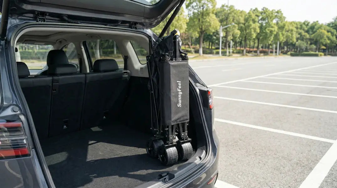 Car with an open trunk and a suitcase labeled 'JET' in a parking lot.