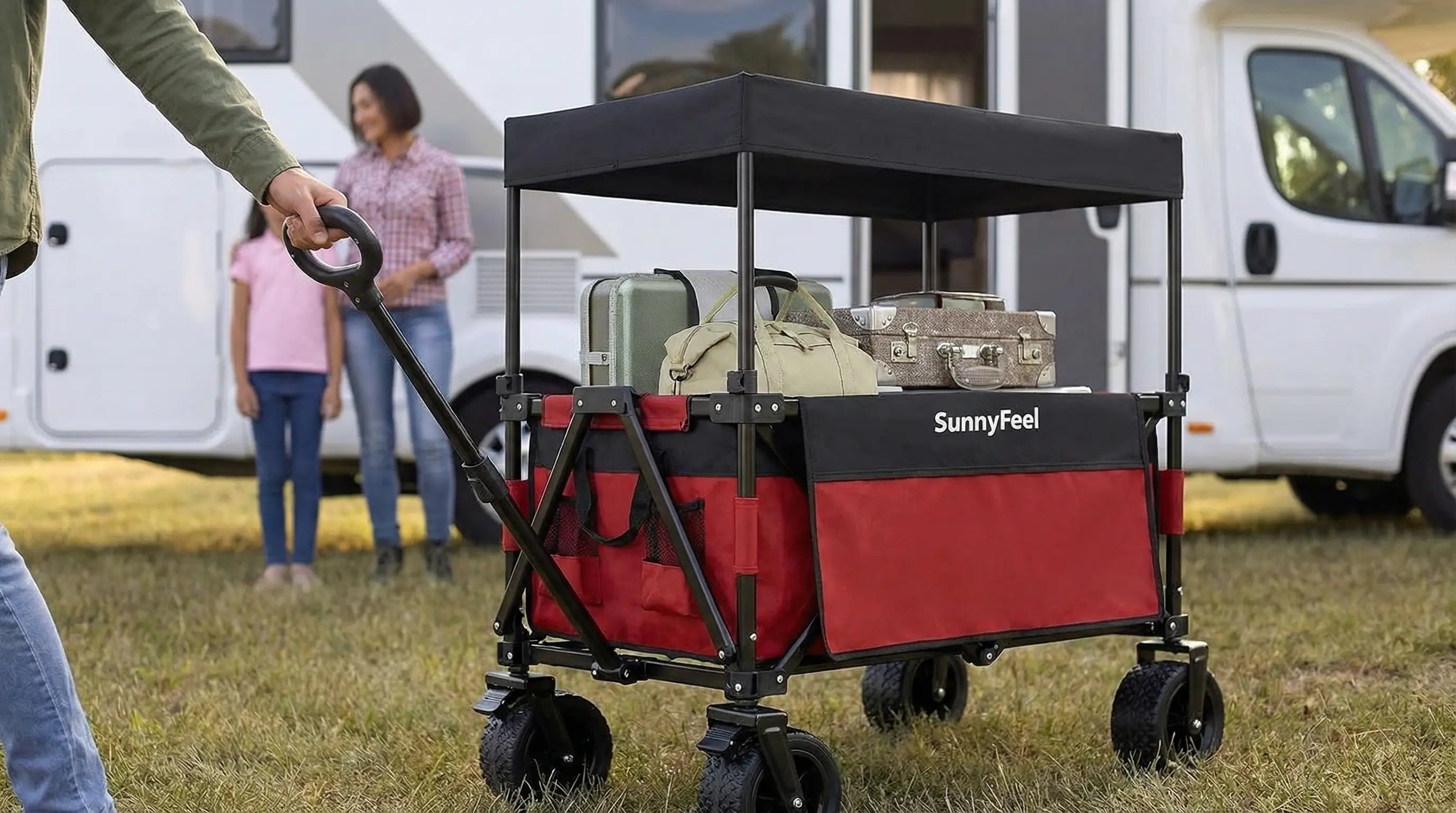 Red and black SunnyFeel wagon with items on a grassy area near a white van.