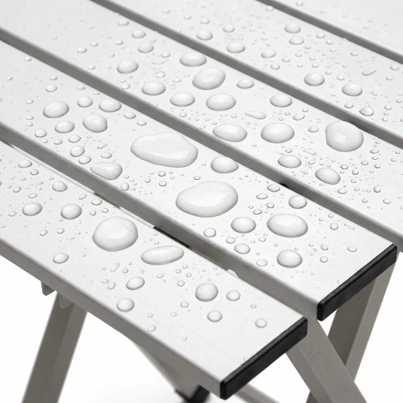 White folding table with water droplets on a white background