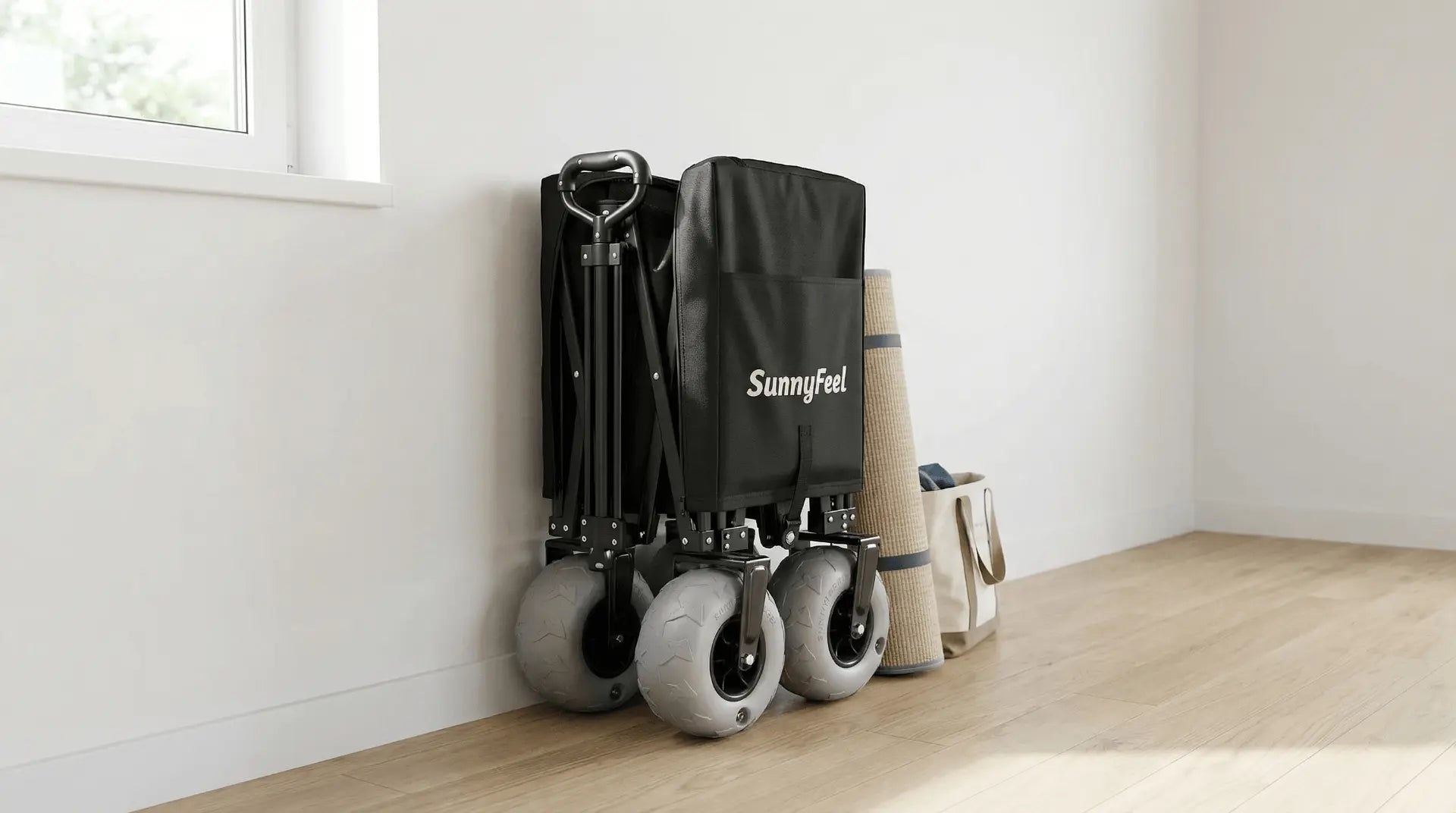 Black folding cart with wheels and a Sunnyfeel bag against a white wall.