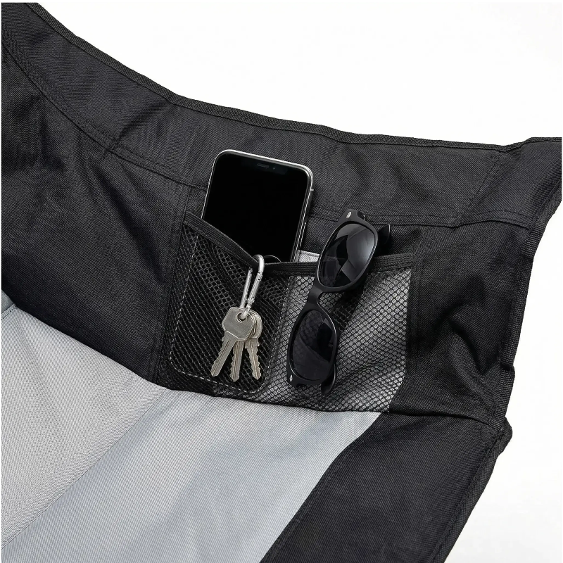 Black and gray bag with a pocket holding a phone, keys, and sunglasses.
